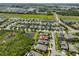 An aerial view of a neighborhood shows the home's location near waterways and green spaces at 6907 Crestpoint Dr, Apollo Beach, FL 33572