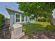 This home features a well-manicured backyard with a generator and green tinted hurricane shutters at 6907 Crestpoint Dr, Apollo Beach, FL 33572