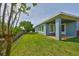 A well-maintained backyard features green grass, a fence, and a covered patio area at 6907 Crestpoint Dr, Apollo Beach, FL 33572