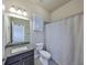 Bathroom displaying granite countertops, tile floors, shower with curtain, and ample lighting at 6907 Crestpoint Dr, Apollo Beach, FL 33572