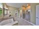 Luxurious bathroom featuring a soaking tub, walk-in shower, and double vanity sinks at 6907 Crestpoint Dr, Apollo Beach, FL 33572