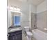 Bathroom featuring a gray vanity, toilet, and tub/shower with gray tile surround at 6907 Crestpoint Dr, Apollo Beach, FL 33572