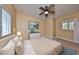 Bedroom featuring a ceiling fan, neutral walls, carpeted floors, and a window with shutters at 6907 Crestpoint Dr, Apollo Beach, FL 33572