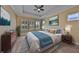 Inviting bedroom featuring a trey ceiling, plantation shutters, and stylish decor at 6907 Crestpoint Dr, Apollo Beach, FL 33572