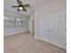 Bright bedroom featuring neutral walls, carpet, ceiling fan, and plantation shutters at 6907 Crestpoint Dr, Apollo Beach, FL 33572