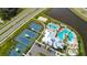 Overhead shot of community amenities, featuring pool, tennis courts, and playground surrounded by lush greenery at 6907 Crestpoint Dr, Apollo Beach, FL 33572