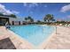 Beautiful community pool with comfortable lounge chairs and a clear blue sky, perfect for relaxation at 6907 Crestpoint Dr, Apollo Beach, FL 33572