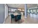 Open-concept dining room with granite table, tile floors, and seamless flow into the living room and kitchen at 6907 Crestpoint Dr, Apollo Beach, FL 33572