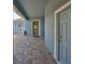 Covered front entryway with brick pavers, leading to a charming front door with decorative glass at 6907 Crestpoint Dr, Apollo Beach, FL 33572