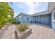 Home displaying a brick paved patio, lush landscaping, and access to the backyard at 6907 Crestpoint Dr, Apollo Beach, FL 33572