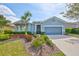 Charming single-story home featuring a beautifully landscaped front yard and a two-car garage at 6907 Crestpoint Dr, Apollo Beach, FL 33572