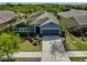 Charming single-story home featuring a well-manicured lawn, beautiful landscaping, and attached two car garage at 6907 Crestpoint Dr, Apollo Beach, FL 33572