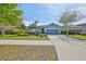 Charming single-story home with a well-manicured front lawn and an attached two-car garage at 6907 Crestpoint Dr, Apollo Beach, FL 33572