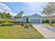 Inviting single-story home boasting a beautifully landscaped yard, attached two car garage, and well-maintained lawn at 6907 Crestpoint Dr, Apollo Beach, FL 33572