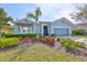 Charming home featuring landscaped front yard, palm tree, and attached two-car garage at 6907 Crestpoint Dr, Apollo Beach, FL 33572