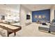 Modern game room with a shuffleboard table and comfortable seating area at 6907 Crestpoint Dr, Apollo Beach, FL 33572