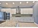 Modern kitchen with granite countertops, mosaic tile backsplash, and stainless steel appliances at 6907 Crestpoint Dr, Apollo Beach, FL 33572