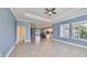 Open-concept living room shows tile floors, a trey ceiling, and seamless access to the kitchen and breakfast bar at 6907 Crestpoint Dr, Apollo Beach, FL 33572