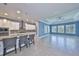 Open-concept living space with a kitchen island, white cabinets, and plenty of natural light at 6907 Crestpoint Dr, Apollo Beach, FL 33572