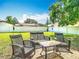 Cozy backyard seating area perfect for entertaining, surrounded by lush greenery and a privacy fence at 714 W Peninsular St, Tampa, FL 33603