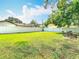 Expansive backyard with lush green lawn, enclosed by a crisp white fence, offering privacy and space at 714 W Peninsular St, Tampa, FL 33603