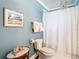 Bathroom featuring toilet and shower with curtain at 714 W Peninsular St, Tampa, FL 33603