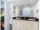 Bathroom featuring a double sink vanity with granite countertops and a large mirror at 714 W Peninsular St, Tampa, FL 33603