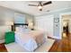 A bedroom features a ceiling fan, white bedding, and hardwood floors at 714 W Peninsular St, Tampa, FL 33603