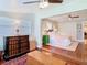 Bedroom view showcasing a ceiling fan, hardwood floors, closet, and attached sitting area at 714 W Peninsular St, Tampa, FL 33603