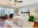 A bedroom features a ceiling fan, hardwood floors, and a view into another room at 714 W Peninsular St, Tampa, FL 33603