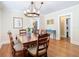 A dining room features hardwood floors, a wood table with seating for six, and a chandelier at 714 W Peninsular St, Tampa, FL 33603