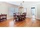 Elegant dining room with hardwood floors, a chandelier, and a large window, ideal for Gathering gatherings at 714 W Peninsular St, Tampa, FL 33603