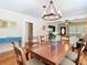A dining room has a view into the living room and features a wood table and chandelier at 714 W Peninsular St, Tampa, FL 33603
