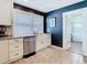 A kitchen features white cabinets and a stainless steel dishwasher at 714 W Peninsular St, Tampa, FL 33603