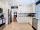 A kitchen features stainless steel appliances, white cabinets, and tile floors at 714 W Peninsular St, Tampa, FL 33603