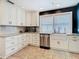 A kitchen features white cabinets, stainless steel appliances, granite countertops, and tile floors at 714 W Peninsular St, Tampa, FL 33603