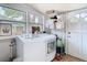 Bright laundry room featuring modern washer and dryer, and convenient shelving at 714 W Peninsular St, Tampa, FL 33603