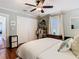 Comfortable main bedroom with a ceiling fan, hardwood floors, and closet at 714 W Peninsular St, Tampa, FL 33603