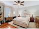 Comfortable main bedroom with a ceiling fan, hardwood floors, and two side tables with lamps at 714 W Peninsular St, Tampa, FL 33603