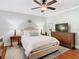Comfortable main bedroom with a ceiling fan, dresser with TV, and two side tables with lamps at 714 W Peninsular St, Tampa, FL 33603