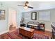 Bright sitting area with a ceiling fan, bench seating, and doorway to a bathroom at 714 W Peninsular St, Tampa, FL 33603