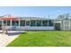 Outdoor entertaining area with covered lanai, lush lawn, patio, shed, and comfortable seating at 731 44Th Ne Ave, St Petersburg, FL 33703