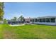 Large backyard with a fenced pool area, patio with outdoor seating, and a well-maintained lawn at 731 44Th Ne Ave, St Petersburg, FL 33703