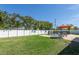 Expansive backyard featuring lush green grass, a fenced pool area, and mature landscaping for added privacy at 731 44Th Ne Ave, St Petersburg, FL 33703