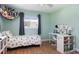 Well-lit bedroom with hardwood flooring featuring a comfortable bed, workspace, and ample storage at 731 44Th Ne Ave, St Petersburg, FL 33703