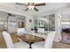 Cozy dining area featuring an oval table, white chairs, and natural light, adjacent to an open kitchen at 731 44Th Ne Ave, St Petersburg, FL 33703