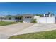 Charming single-story home with a well-manicured lawn, white exterior, driveway, garage, and RV parking at 731 44Th Ne Ave, St Petersburg, FL 33703