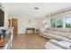 Bright living room with a comfortable sofa, wood-look flooring, and access to the outdoors at 731 44Th Ne Ave, St Petersburg, FL 33703