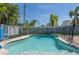 Inviting pool area featuring clear blue water, a basketball hoop, and surrounding patio space at 731 44Th Ne Ave, St Petersburg, FL 33703