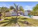 Outdoor space includes a shed, palm trees, tropical landscaping and outdoor seating area at 747 39Th Ne Ave, St Petersburg, FL 33703